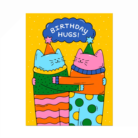 A blue and pink cat dressed in colorful outfits with party hats on are hugging each other wit ha blue cloud with lettering that says Birthday Hugs! and a yellow background with small white polka dots